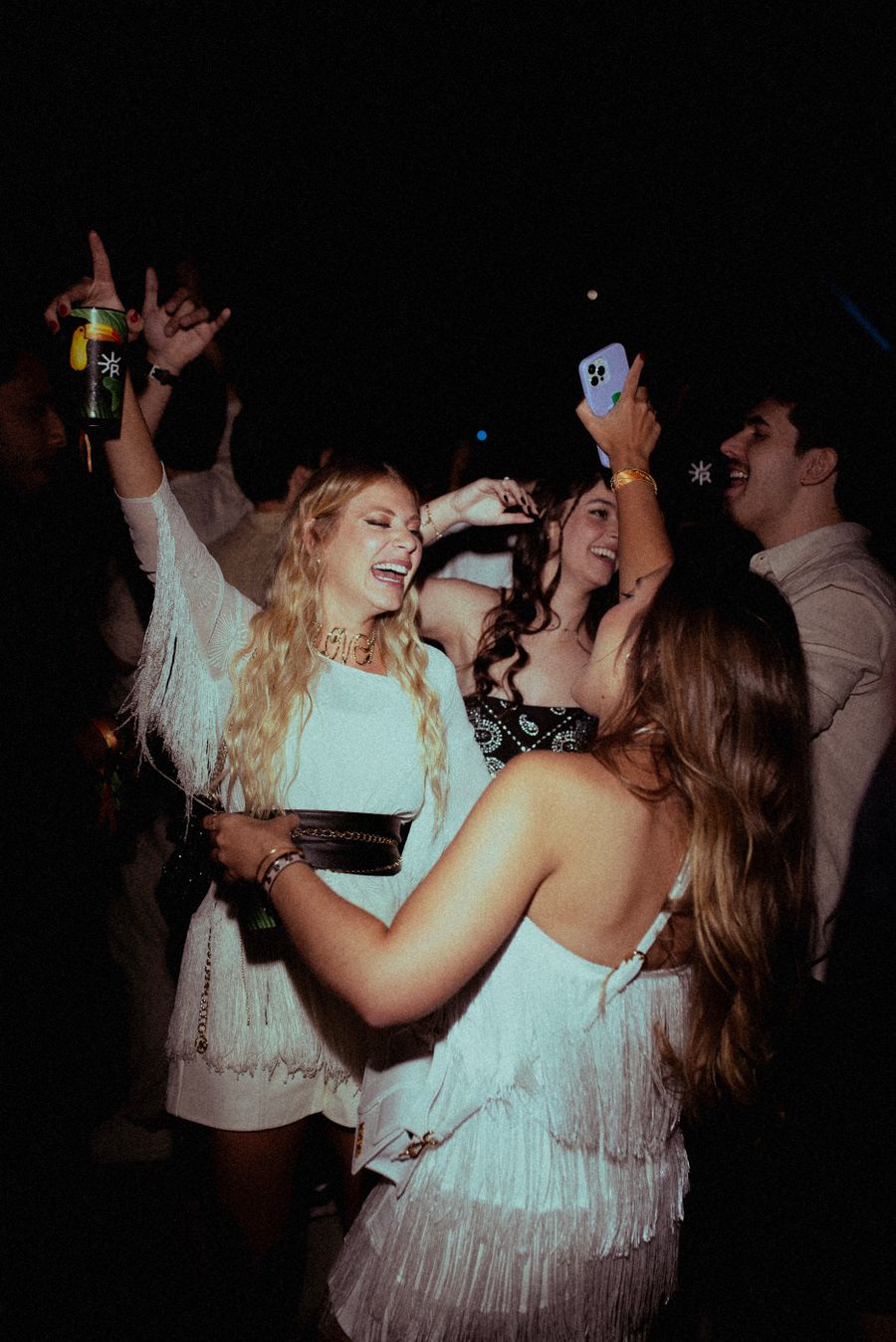 Friends dancing together at a lively night out