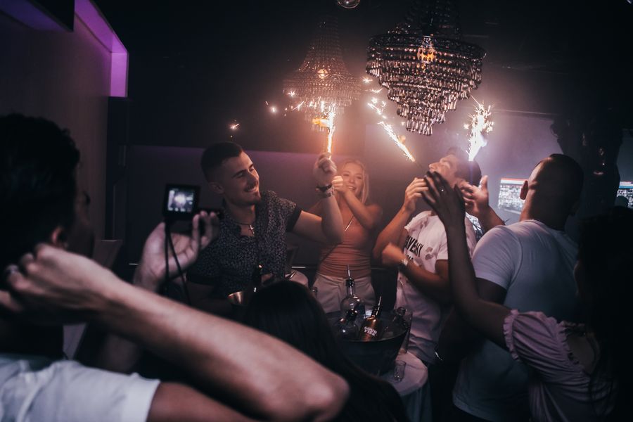Friends celebrating together beneath warm party lights