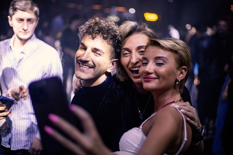 A group of friends taking a joyful photo at a party