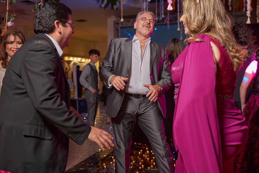 Friends dressed up and laughing together at an evening party